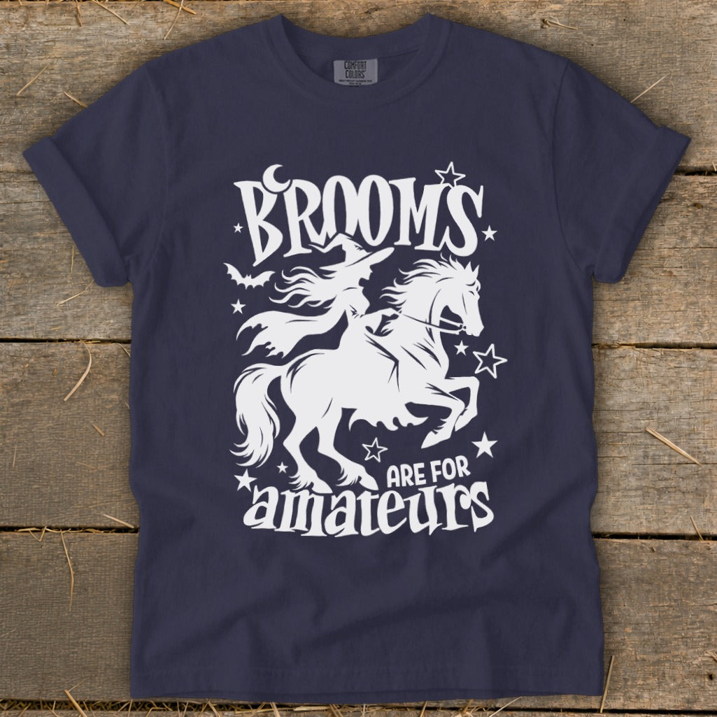 Navy t-shirt with white graphic of a witch on a horse and text "Brooms Are For Amateurs".