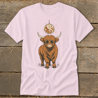 Highland cow with sunglasses and disco ball graphic on pink t-shirt.