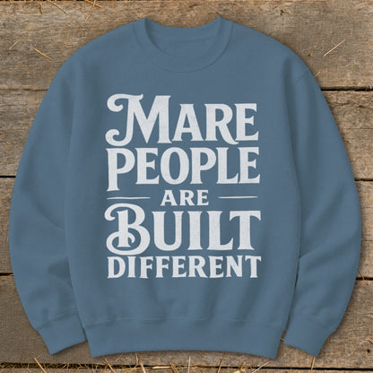 Blue sweatshirt with white text: "Mare People Are Built Different"