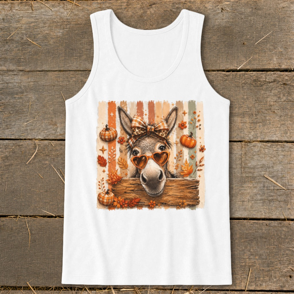 Donkey wearing heart sunglasses and bow in front of autumn leaves and pumpkins.