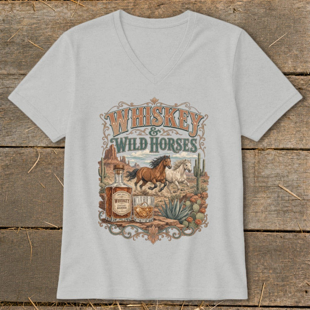 T-shirt with "Whiskey & Wild Horses" text, horses, whiskey bottle, and desert landscape.
