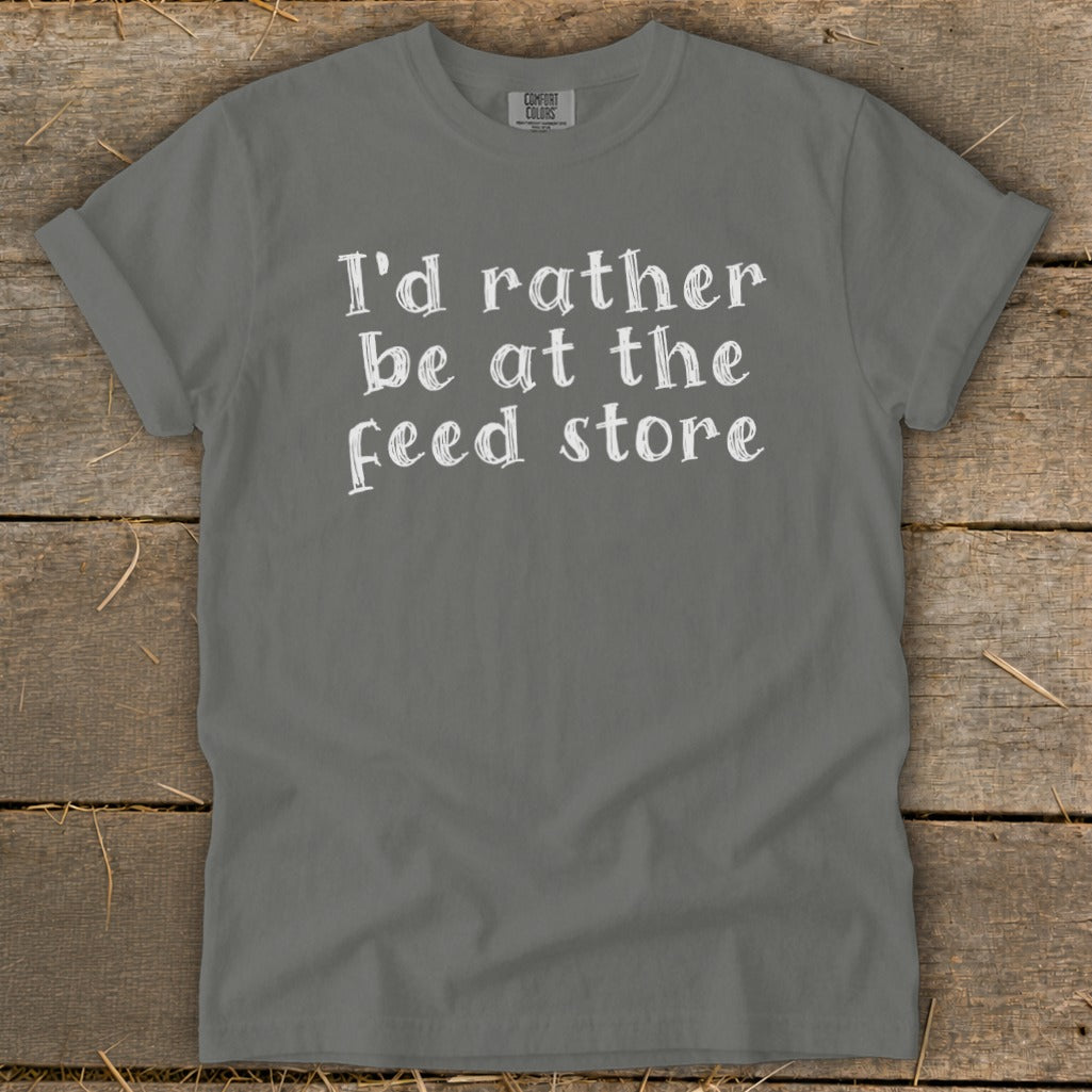Gray Comfort Colors t-shirt with white text: "I'd rather be at the feed store."