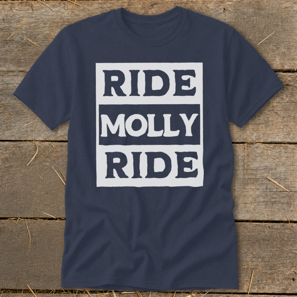 Dark blue t-shirt featuring a white rectangular graphic with the text RIDE MOLLY RIDE laid flat on a rustic wooden background.