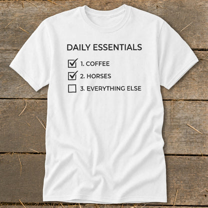 White t-shirt with "Daily Essentials: 1. Coffee, 2. Horses, 3. Everything Else" list.