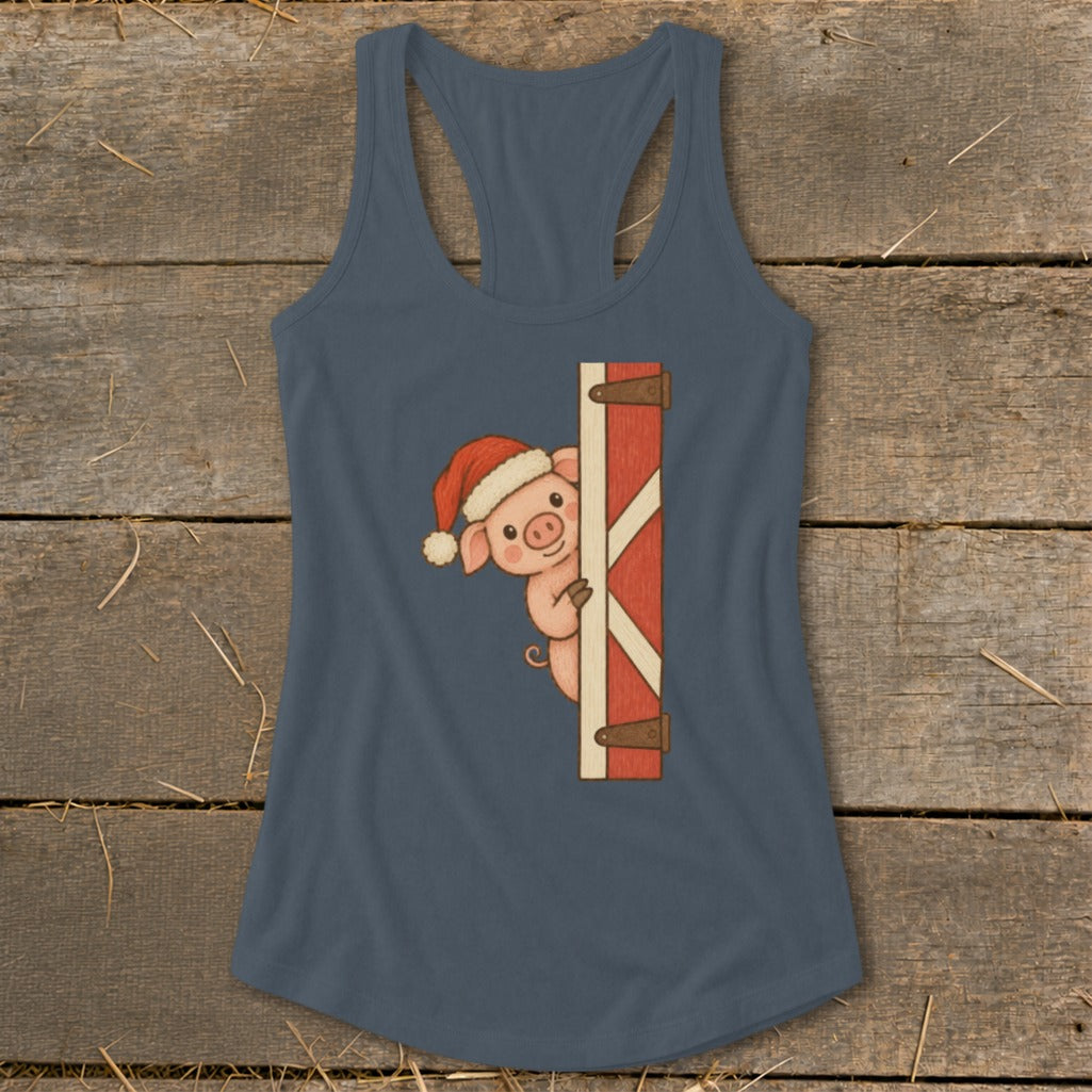 Pig in Santa hat peeking from behind barn door on a dark blue tank top.