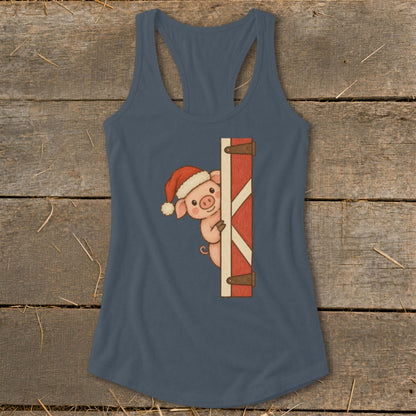 Pig in Santa hat peeking from behind barn door on a dark blue tank top.