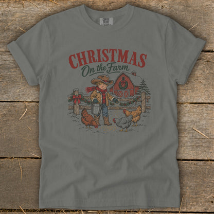 Christmas On the Farm graphic of a boy feeding chickens near a red barn.