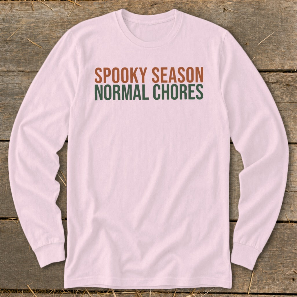 Pink long-sleeve shirt with "SPOOKY SEASON" and "NORMAL CHORES" text.