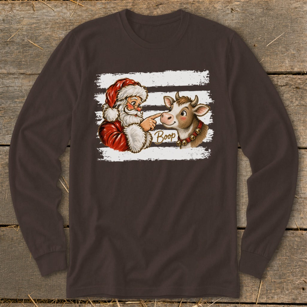 Santa playfully booping a cow's nose with the word "Boop" on a long-sleeve shirt.