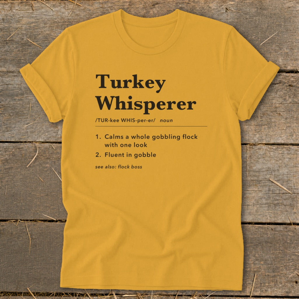 Yellow t-shirt with "Turkey Whisperer" definition and turkey-related phrases.