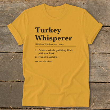 Yellow t-shirt with "Turkey Whisperer" definition and turkey-related phrases.