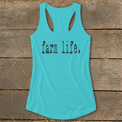 Turquoise tank top with "farm life." text on a wooden background.