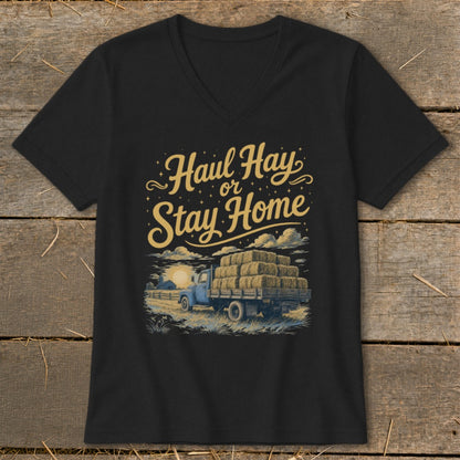 Black t-shirt with "Haul Hay or Stay Home" text above a hay-filled truck at sunset.