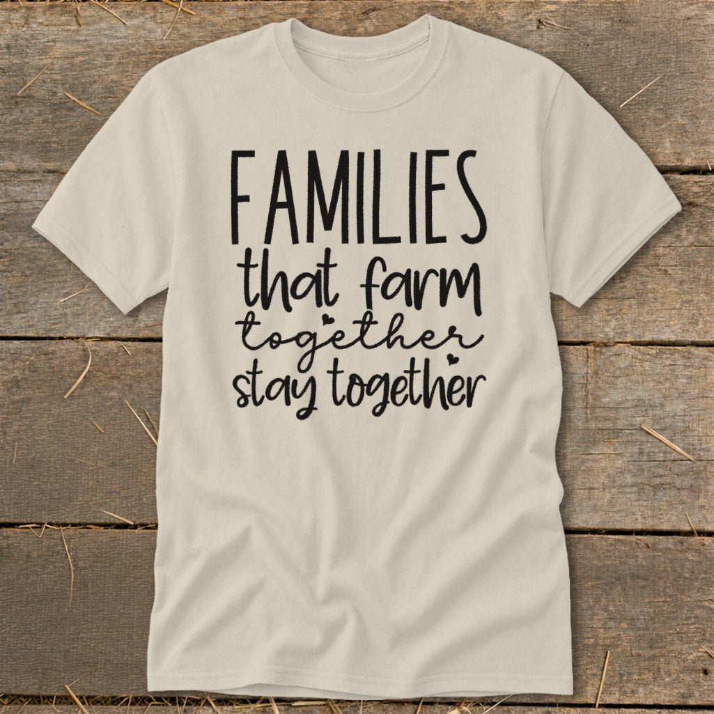 Light-colored t-shirt with black text "FAMILIES that farm together stay together."