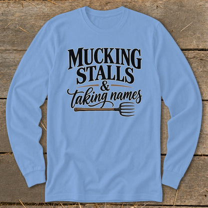 Light blue long-sleeved shirt with "Mucking Stalls & Taking Names" and a pitchfork.