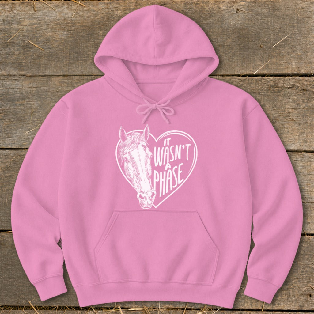 Pink hoodie with a white heart graphic featuring a horse and the text "It wasn't a phase."