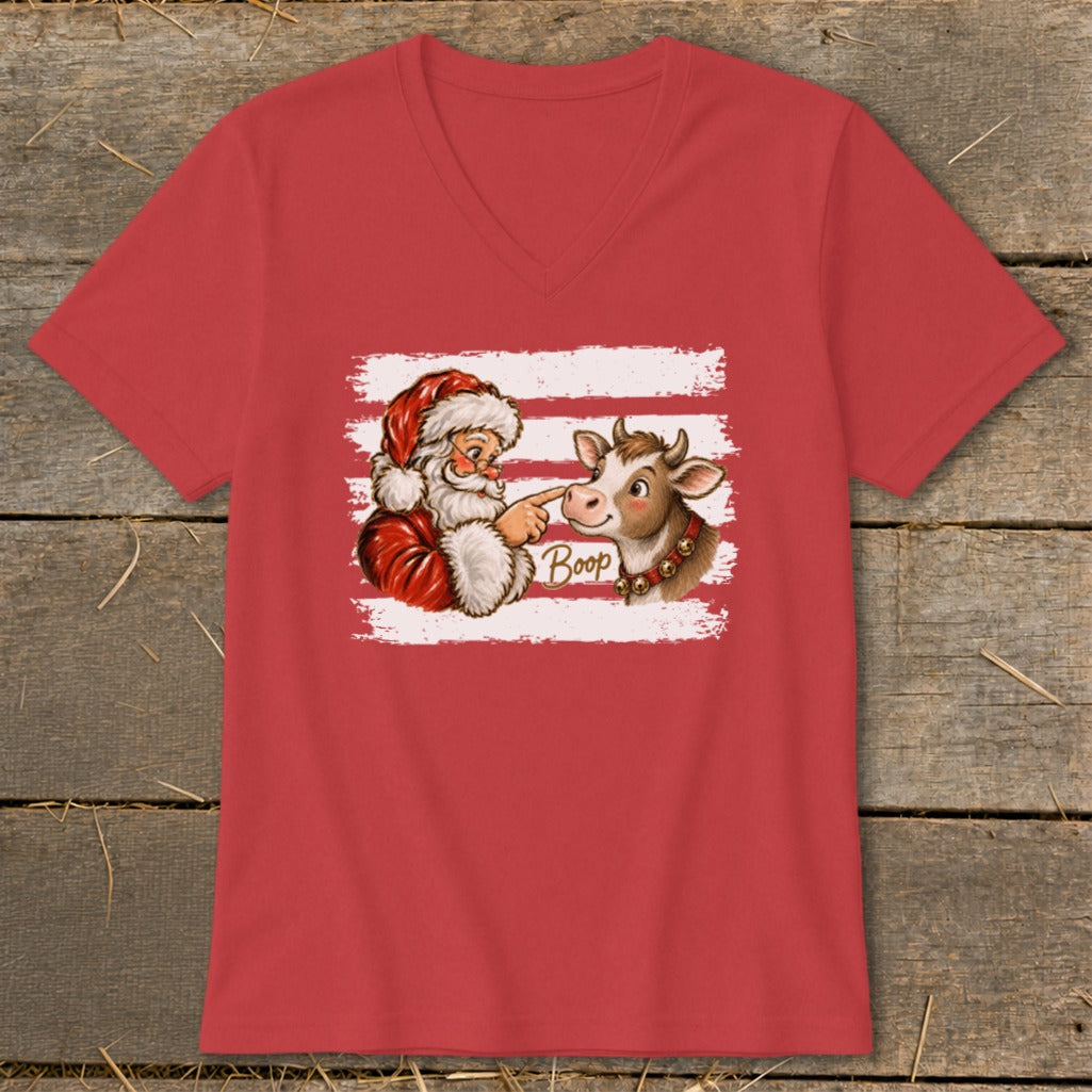 Santa booping a cow on the nose, with the word "Boop" on a red t-shirt.