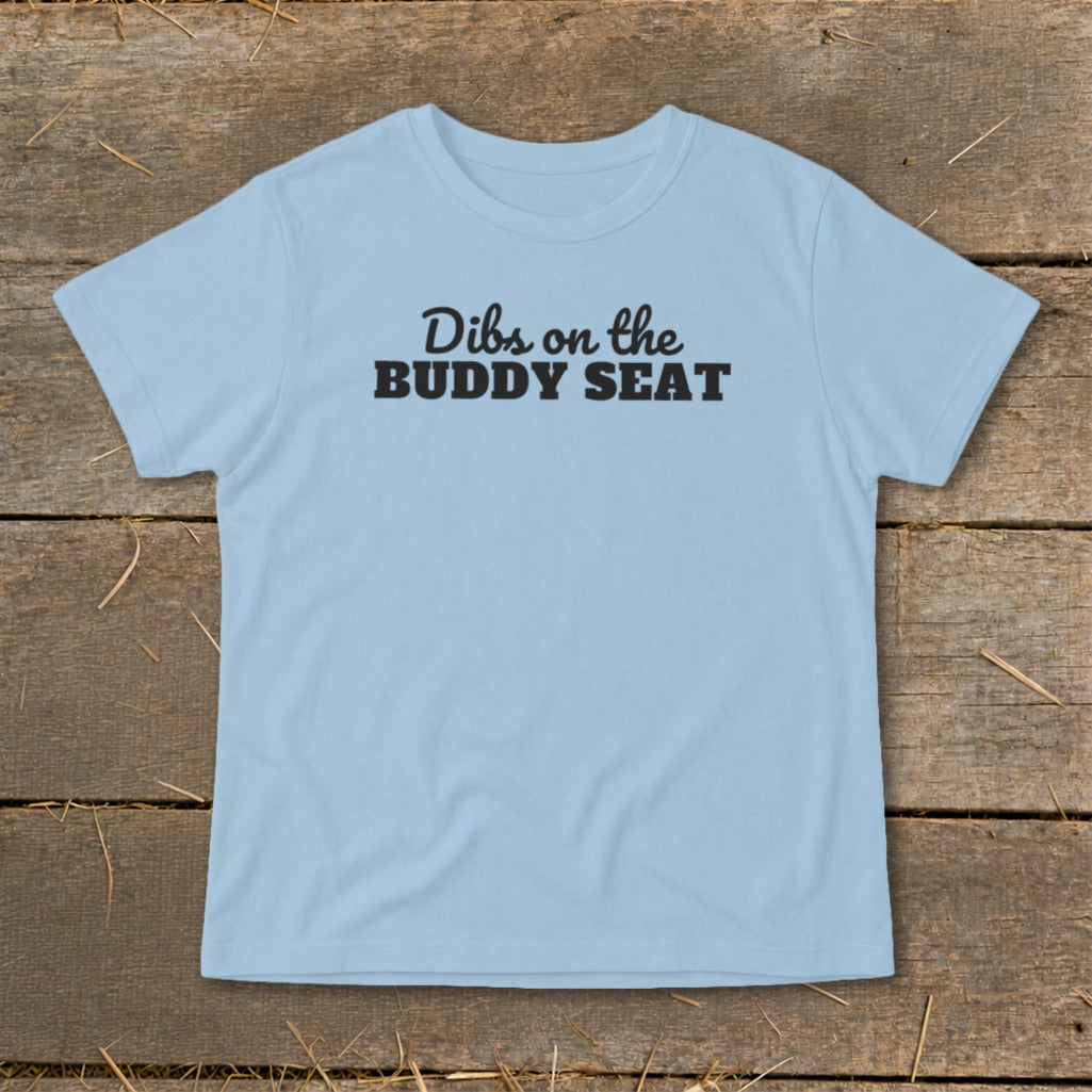 Light blue t-shirt with black text that reads "Dibs on the BUDDY SEAT".