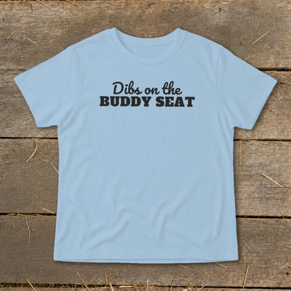 Light blue t-shirt with black text that reads "Dibs on the BUDDY SEAT".