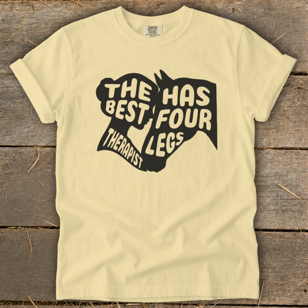 Cream t-shirt with black graphic: "The best therapist has four legs" and horse head silhouette.