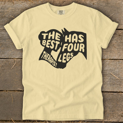 Cream t-shirt with black graphic: "The best therapist has four legs" and horse head silhouette.