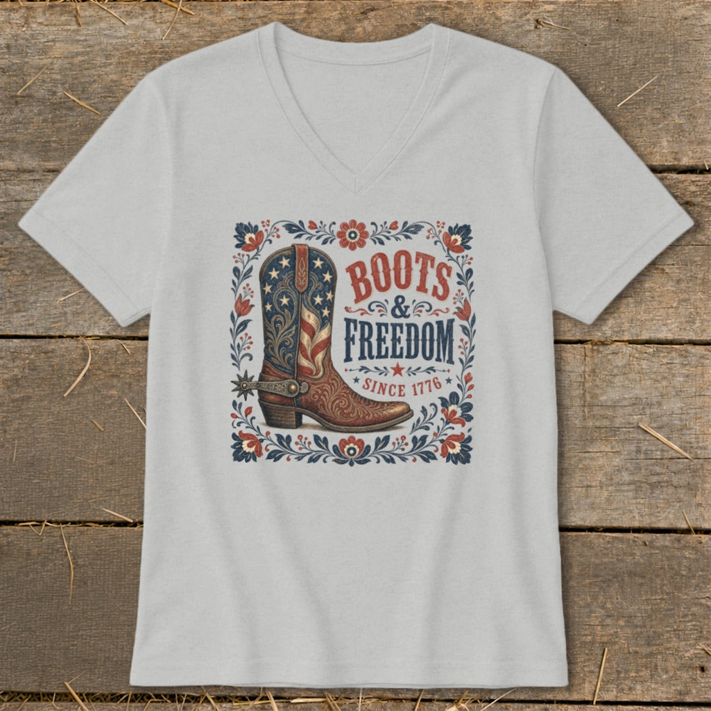 Light grey t-shirt with a distressed cowboy boot featuring the American flag and "Boots & Freedom Since 1776" text.