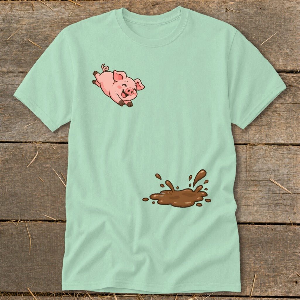 Light mint t-shirt with a cartoon pig jumping above a mud splatter.