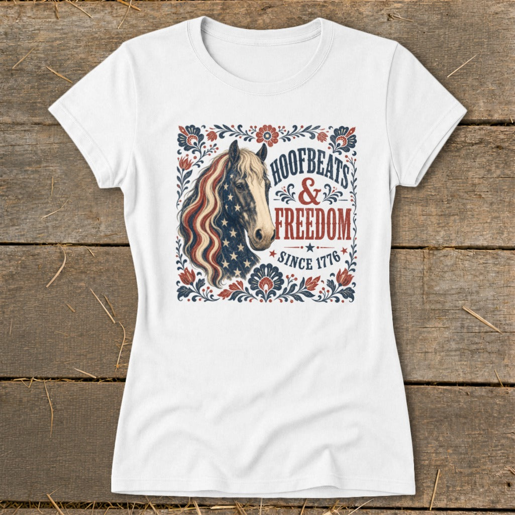 White t-shirt featuring a patriotic horse graphic with text "Hoofbeats & Freedom Since 1776".