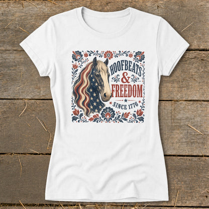 White t-shirt featuring a patriotic horse graphic with text "Hoofbeats & Freedom Since 1776".