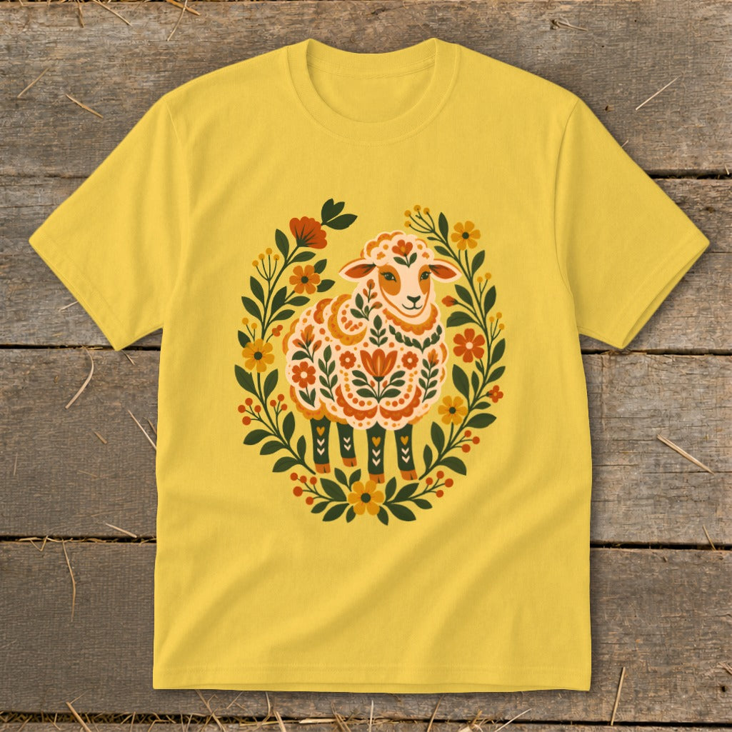 Yellow t-shirt with a folk art sheep surrounded by floral wreath.
