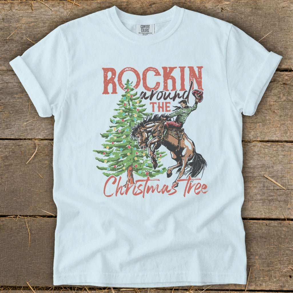 White t-shirt with "Rockin' Around The Christmas Tree" graphic and bucking bronco rider.