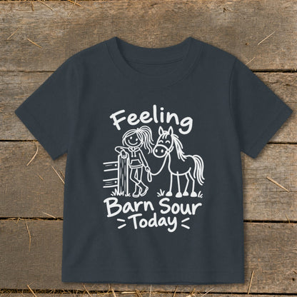 White graphic on dark shirt with text "Feeling Barn Sour Today" and drawings of a girl and horse.