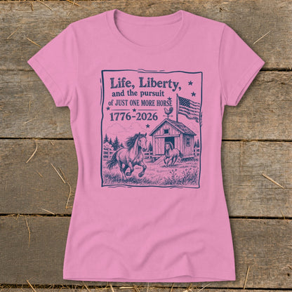Pink t-shirt with graphic of horses, barn, American flag, and text.