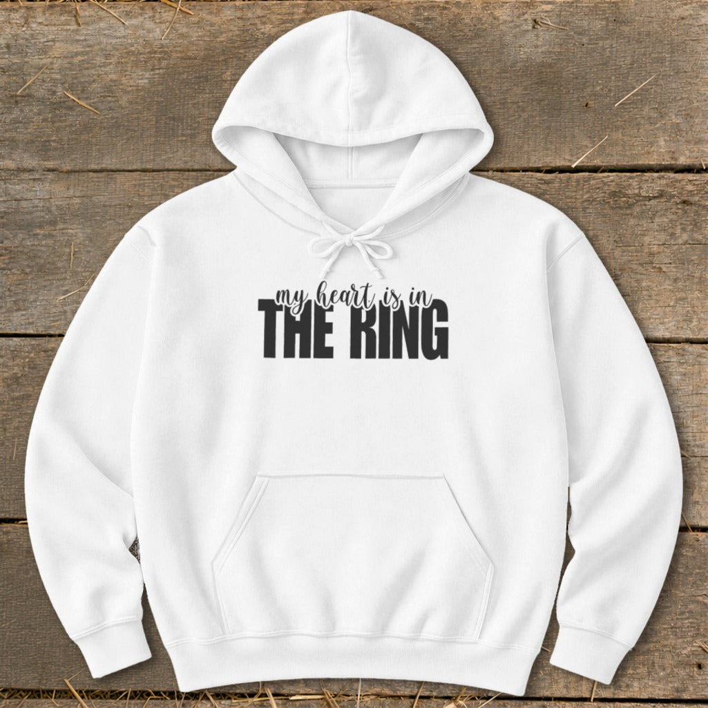 A white hooded sweatshirt with the black text my heart is in THE RING centered on the chest.