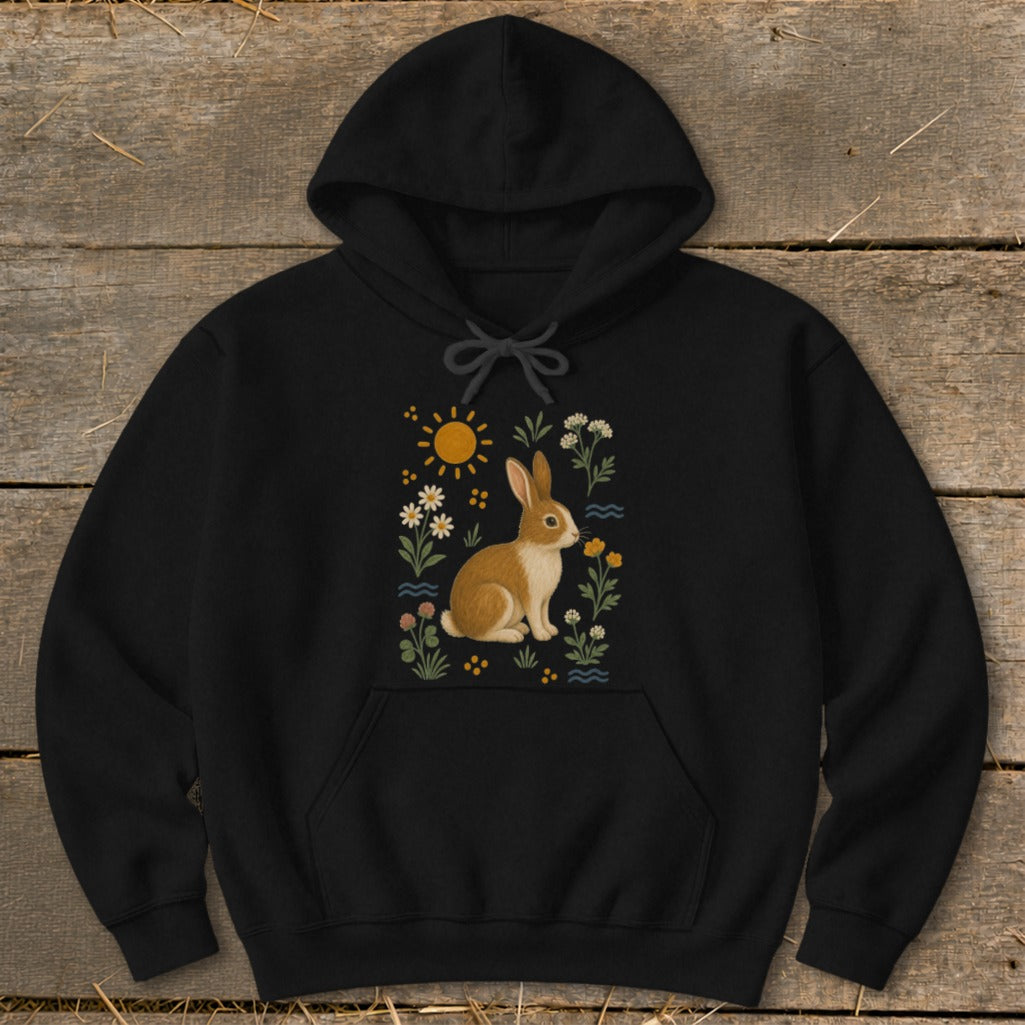 Black hoodie with a brown and white rabbit surrounded by flowers and a sun.