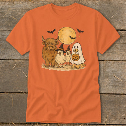Highland cow, chicks, and dog in Halloween costumes under a moon with bats.