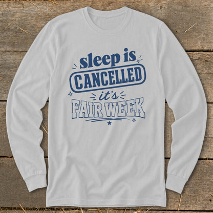 White long sleeve shirt with "sleep is CANCELLED it's FAIR WEEK" in blue text.