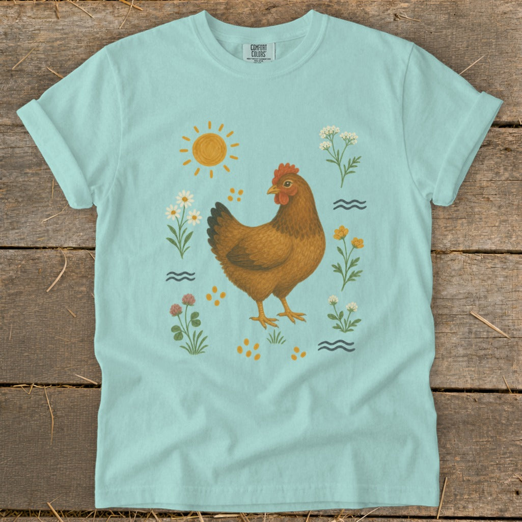 Light blue t-shirt with a brown chicken and flowers illustration.