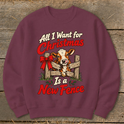 Burgundy sweatshirt with a cow behind a fence, text "All I Want for Christmas Is a New Fence".