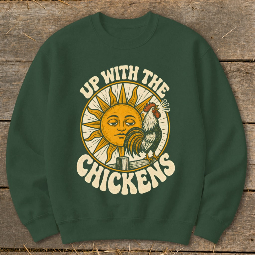 Dark green crewneck sweatshirt featuring a graphic of a rooster crowing in front of a sun and the text Up With The Chickens.