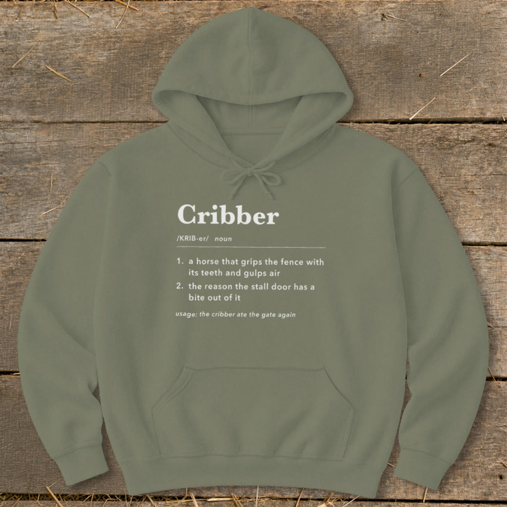 An olive green hoodie printed with a humorous dictionary definition of the word cribber.