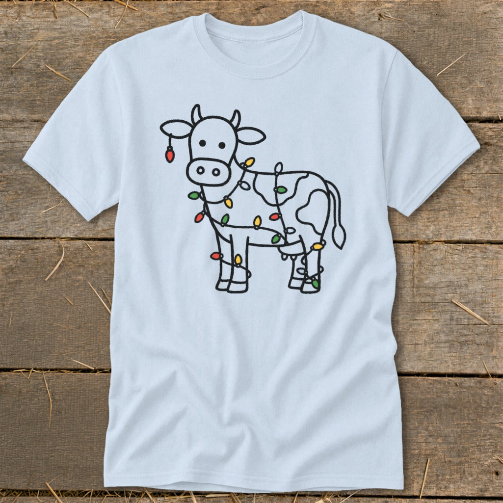 Light blue t-shirt with a black outline of a cow decorated with colorful Christmas lights.