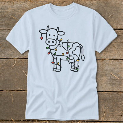Light blue t-shirt with a black outline of a cow decorated with colorful Christmas lights.