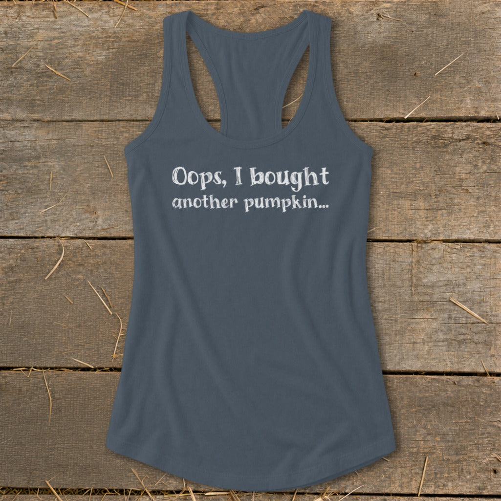 Tank top with white text "Oops, I bought another pumpkin..." on wood background.