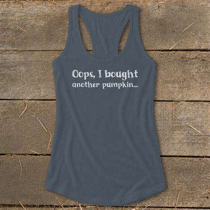 Tank top with white text "Oops, I bought another pumpkin..." on wood background.