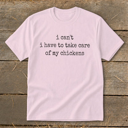 Pink t-shirt with black text: "i can't i have to take care of my chickens".