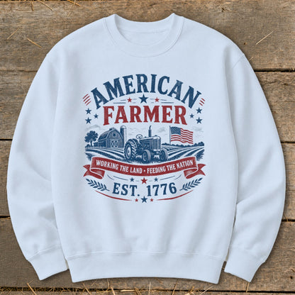 White sweatshirt with "American Farmer" graphic, tractor, barn, and flag.