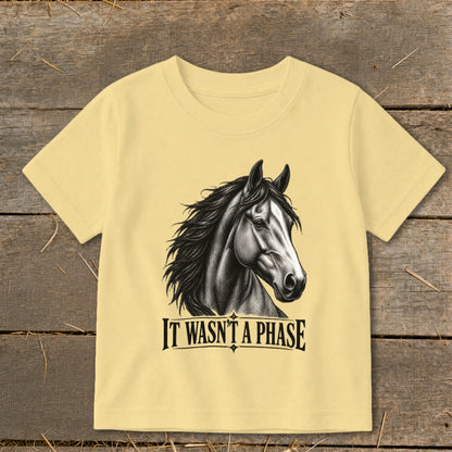 Light yellow t-shirt with a black and white sketch of a horse and text "IT WASN'T A PHASE".