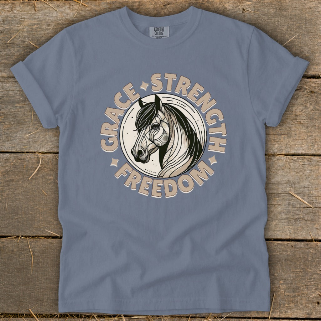 Blue t-shirt with a circular graphic of a horse's head and text "Grace Strength Freedom".