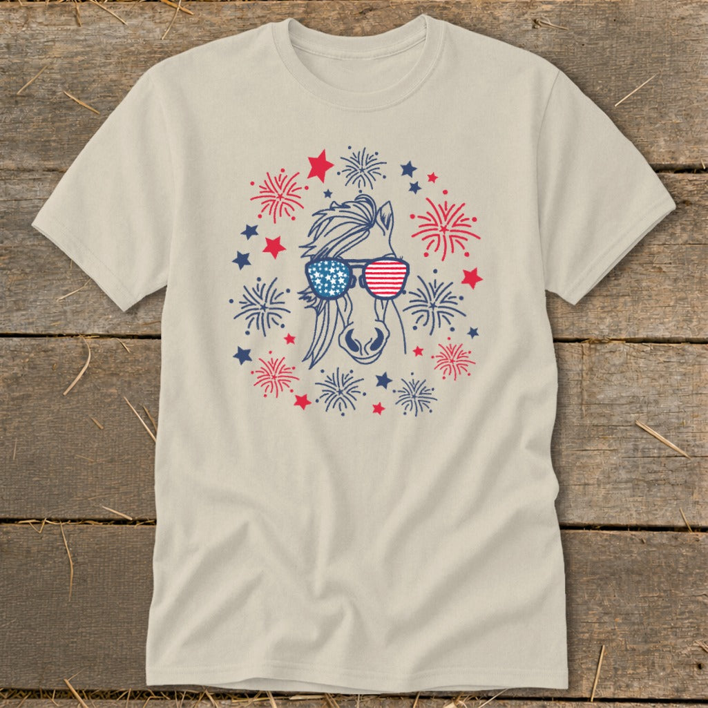 Horse wearing American flag sunglasses surrounded by red, white, and blue fireworks and stars.
